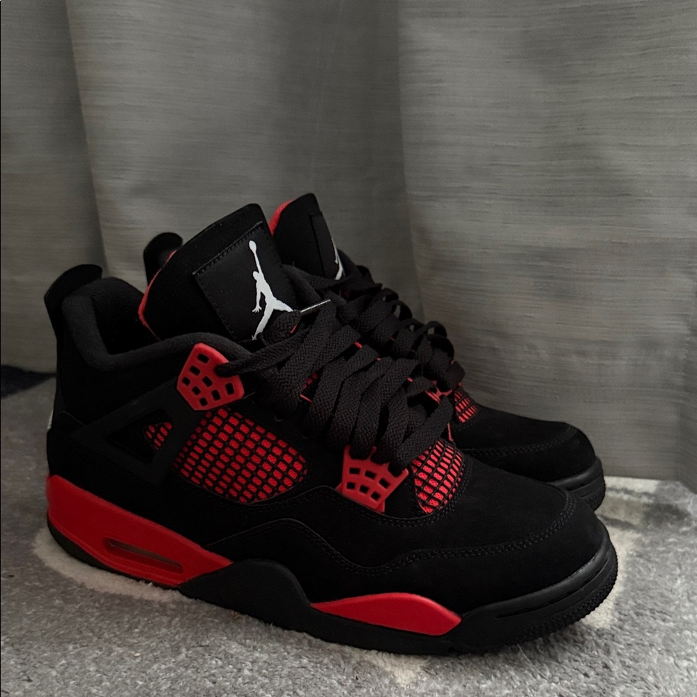 Men’s Red Thunder Jordan 4s.